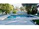 Relaxing outdoor pool with an expansive deck surrounded by mature trees and lush landscaping at 3714 Virginia Dr, Orlando, FL 32803