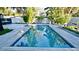 Backyard pool surrounded by well manicured landscaping and paver deck at 3714 Virginia Dr, Orlando, FL 32803
