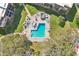 Aerial view of community pool with lounge chairs and well maintained landscape at 3800 Saxon Dr # 19B, New Smyrna Beach, FL 32169