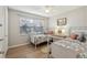 Bright bedroom with twin beds, natural light, and view of adjacent bathroom at 3800 Saxon Dr # 19B, New Smyrna Beach, FL 32169