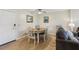 A bright dining area with a modern table set, hardwood floors, and a comfortable sofa nearby at 3800 Saxon Dr # 19B, New Smyrna Beach, FL 32169