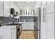 Modern kitchen featuring white cabinets, stainless steel appliances, and sleek backsplash for a clean, updated look at 3800 Saxon Dr # 19B, New Smyrna Beach, FL 32169