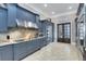 Well-appointed kitchen featuring custom cabinetry, granite countertops, and state-of-the-art stainless steel appliances at 415 Muirfield Loop, Reunion, FL 34747