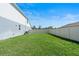 Side yard with green lawn and white vinyl fence, creating a private and serene outdoor space at 4210 Sunset Preserve Blvd, Orlando, FL 32820