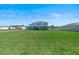 Large backyard featuring a manicured lawn and a covered patio, ideal for entertaining or relaxing at 4210 Sunset Preserve Blvd, Orlando, FL 32820