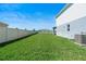 Large, grassy side yard with a clean white fence, perfect for a garden or play area at 4210 Sunset Preserve Blvd, Orlando, FL 32820