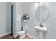 Charming powder room features a pedestal sink, hexagon shelving, and attractive blue door at 4210 Sunset Preserve Blvd, Orlando, FL 32820