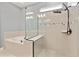 Luxurious bathroom featuring a soaking tub and separate shower with glass enclosure and modern fixtures at 4210 Sunset Preserve Blvd, Orlando, FL 32820