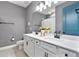 Well-lit bathroom with double vanity, stylish fixtures, and white cabinets at 4210 Sunset Preserve Blvd, Orlando, FL 32820