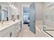 Bathroom featuring double vanity, tub and view of bedroom at 4210 Sunset Preserve Blvd, Orlando, FL 32820