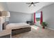 Bright bedroom with vaulted ceiling features large window with red curtains, and includes a ceiling fan at 4210 Sunset Preserve Blvd, Orlando, FL 32820