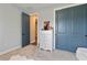 Tastefully decorated bedroom with carpet, blue doors, and neutral colored walls at 4210 Sunset Preserve Blvd, Orlando, FL 32820