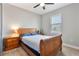 Comfortable bedroom featuring a carved wooden bed frame, side tables, and a sunlit window at 4210 Sunset Preserve Blvd, Orlando, FL 32820