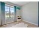 Bright bedroom featuring a large window and a decorative cabinet with natural lighting at 4210 Sunset Preserve Blvd, Orlando, FL 32820