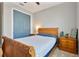 Comfortable bedroom features a wood sleigh bed, sliding closet doors, and stylish furnishings at 4210 Sunset Preserve Blvd, Orlando, FL 32820