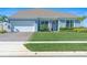 Charming single-Gathering home showcasing a manicured lawn and attached two-car garage at 4210 Sunset Preserve Blvd, Orlando, FL 32820