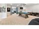 Spacious game room with a pool table, TV, and comfortable seating area at 4210 Sunset Preserve Blvd, Orlando, FL 32820