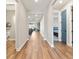 Spacious hallway with hardwood floors leading to various rooms in the home at 4210 Sunset Preserve Blvd, Orlando, FL 32820