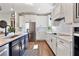 Open kitchen with white cabinets, stainless steel appliances, and a modern design at 4210 Sunset Preserve Blvd, Orlando, FL 32820