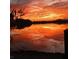 Beautiful lake view at sunset, reflecting warm orange and pink hues at 4210 Sunset Preserve Blvd, Orlando, FL 32820