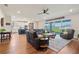 Spacious living room and kitchen area featuring sliding glass doors and leather furniture at 4210 Sunset Preserve Blvd, Orlando, FL 32820