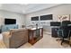 Comfortable living area featuring modern decor, neutral walls, and large windows that provide natural light at 4210 Sunset Preserve Blvd, Orlando, FL 32820