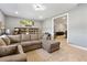 Spacious living room with large sectional sofa and seamless flow into game room at 4210 Sunset Preserve Blvd, Orlando, FL 32820