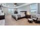 Large main bedroom featuring neutral tones, tray ceilings, and dual windows at 4210 Sunset Preserve Blvd, Orlando, FL 32820