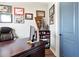 Home office featuring a large desk, comfortable executive chair, and military memorabilia at 4210 Sunset Preserve Blvd, Orlando, FL 32820