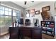 Bright office space with a large desk, built-in bookcase, and a view to the outdoors at 4210 Sunset Preserve Blvd, Orlando, FL 32820