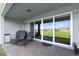 Covered patio with sliding glass doors and sun loungers, offering a seamless transition to the backyard at 4210 Sunset Preserve Blvd, Orlando, FL 32820