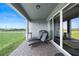 Enjoy outdoor living on this covered patio with sun loungers and access to the lush backyard at 4210 Sunset Preserve Blvd, Orlando, FL 32820