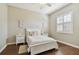 Cozy bedroom with hardwood floors, bright white trim and fixtures, and a large sunny window at 442 Devon Pl, Lake Mary, FL 32746