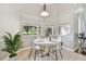Bright breakfast nook featuring white table and chairs, and large windows with views of the landscaped yard at 442 Devon Pl, Lake Mary, FL 32746