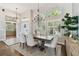 Dining room featuring large windows, a modern chandelier, and stylish table with seating for six at 442 Devon Pl, Lake Mary, FL 32746