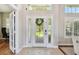 Elegant front entry with decorative glass door, sidelights, transom, and neutral tile floor at 442 Devon Pl, Lake Mary, FL 32746