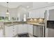 Bright kitchen with granite countertops, stainless steel appliances, and ample cabinet space at 442 Devon Pl, Lake Mary, FL 32746