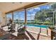 Screened lanai featuring a pool and beautiful waterfront view, perfect for relaxation and outdoor enjoyment at 442 Devon Pl, Lake Mary, FL 32746