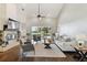 Open concept living room with vaulted ceilings, fireplace, and large windows overlooking the backyard at 442 Devon Pl, Lake Mary, FL 32746