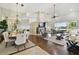 Bright, open-concept living room featuring high ceilings, wood floors, and views of the lake and patio at 442 Devon Pl, Lake Mary, FL 32746
