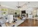 Open concept living room with vaulted ceilings, fireplace, and an adjacent dining area at 442 Devon Pl, Lake Mary, FL 32746