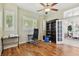 Office featuring hardwood floors, ceiling fan, natural light, and French doors leading to dining room at 442 Devon Pl, Lake Mary, FL 32746