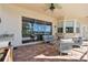 Covered patio with outdoor kitchen, dining area, and comfortable seating overlooking the pool at 442 Devon Pl, Lake Mary, FL 32746
