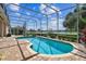 Inviting screened-in pool with brick patio overlooking lush landscaping and tranquil water view at 442 Devon Pl, Lake Mary, FL 32746