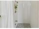 Clean and well-maintained shower with white tiles, mosaic floor, and brass shower fixtures at 442 Devon Pl, Lake Mary, FL 32746