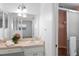 Bathroom featuring a pink countertop, framed mirror, shower with glass door, and vintage lighting at 4913 E Wind St, Orlando, FL 32812