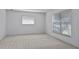 Neutral bedroom featuring two windows with blinds and carpeted floors at 4913 E Wind St, Orlando, FL 32812