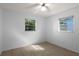 Bright bedroom with neutral walls, tile flooring, and ceiling fan with a light fixture at 4913 E Wind St, Orlando, FL 32812