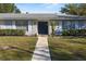 Close-up of the house facade showcasing stone detail and a dark-blue front door at 4913 E Wind St, Orlando, FL 32812