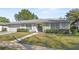 Well-maintained single-story home with stone accents, shutters, and a green lawn at 4913 E Wind St, Orlando, FL 32812